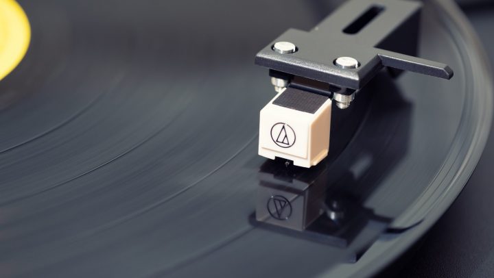 Turntable Cartridge Sitting on Top of a Record.